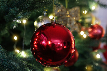 Beautifully decorated Christmas tree with red bauble, closeup
