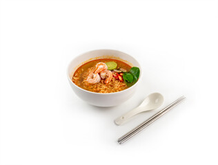Side view of Tom Yum Kung noodle in white bow with chopsticks and spoon isolated on white background
