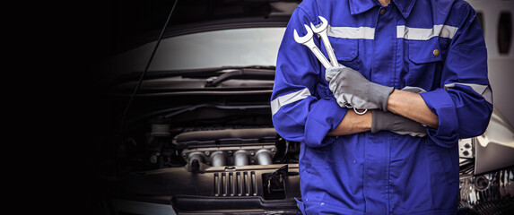 Car care maintenance and servicing, Close-up hand technician auto mechanic holding the wrench for...