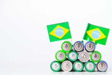 Battery. A lot of batteries on the background of the flag of the country.