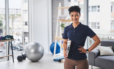 Im a specialist at getting you back to full health. Portrait of a young and confident physiotherapist posing inside her office at a clinic.