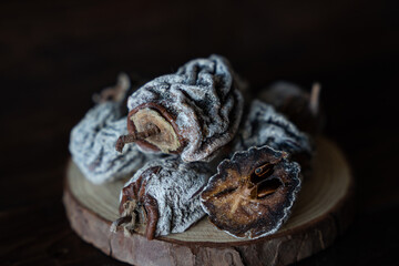 Dried persimmon on a wooden background. Healthy diet