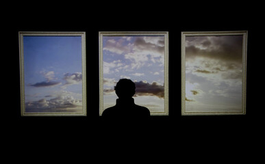 Silhouette of a man watching a digital image of the sky