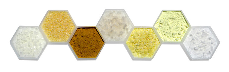 Chemical ingredient in hexagonal molecular shaped container. Microcrystalline Wax, Candelilla Wax, Curcuma Powder, Flake Salt, Sodium Sulfide Flakes, Sulfur Powder and Cetyl Esters Wax
