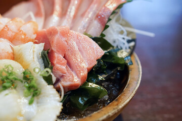 The sashimi set is beautifully arranged in a wooden plate. Japanese Cuisine Buffet. Chef's Choice: tuna, engawa, shrimp and hamachi