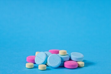 Pharmaceutical pills, tablets, medication on blue background