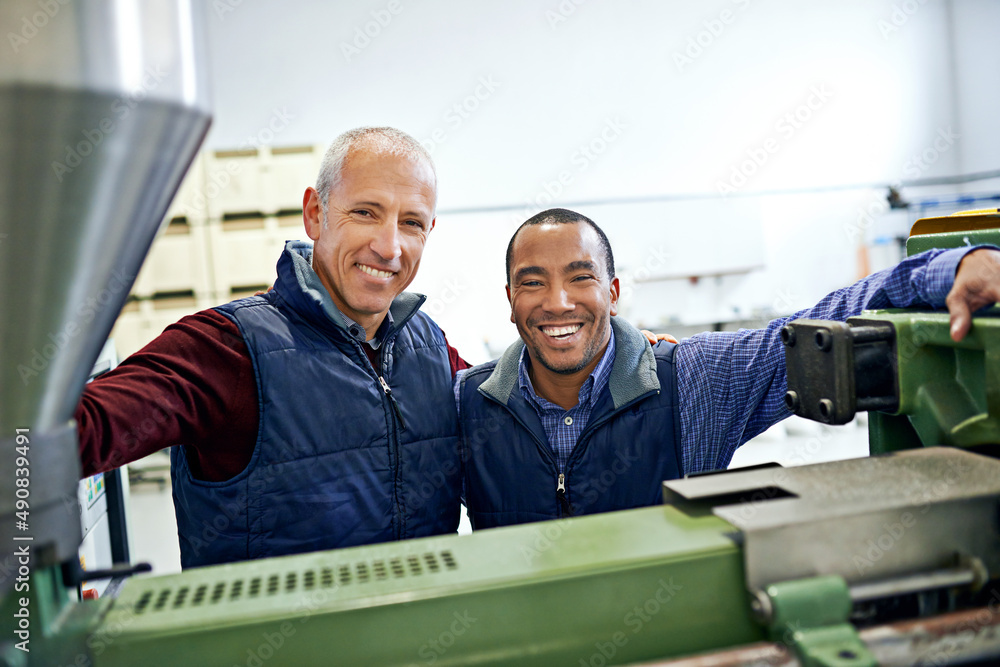 Aufkleber together we make this machine run smoothly. shot of two men working over factory machinery.