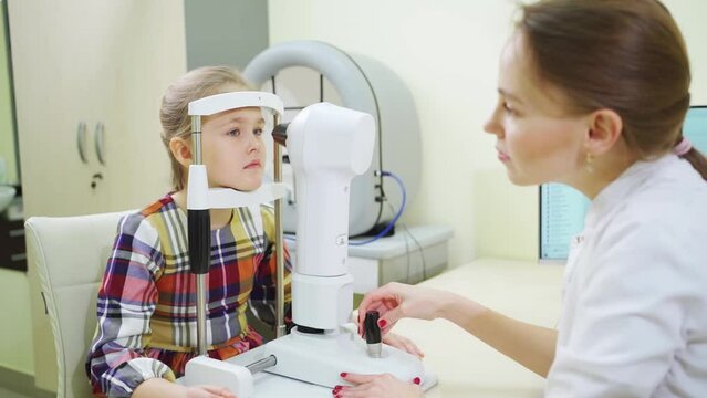 ophthalmologist examines the girl on a corneo topographer. modern clinic.