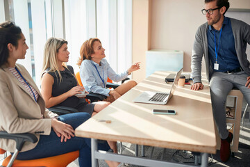 business people working together in the office.Woman talking with man colleagues