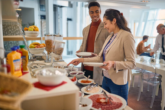 Young business people are enjoying in self service of delicious food at the canteen. Business, people, company
