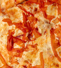 Pizza with tomato and cheese as background.