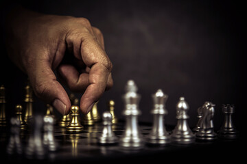 Hand choose chess stand on chessboard with king concept of team player or business team and leadership strategy and human resources organization management or goal to win or strong winner.