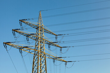 High voltage power pole clear blue sky
