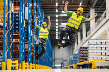 The warehouse workers jumping for joy and success.