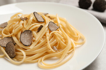 Tasty fettuccine with truffle on plate, closeup