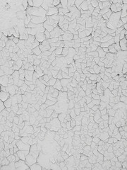 Cracked white paint on the wall as an abstract background.