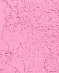 Cracked pink paint on the wall as an abstract background.