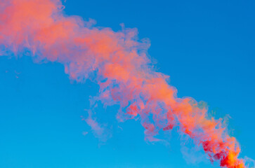 Red smoke on a blue background.