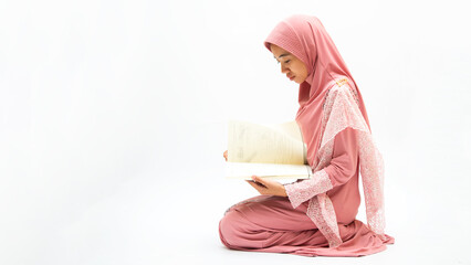 Asian Muslim woman in a veil standing and praying with Kaaba and on white background. Concept of...