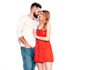 Sexy smiling beautiful woman and her handsome boyfriend. Happy cheerful family having tender moments near pink wall in studio.Pure cheerful models hugging.Embracing each other. Cheerful and happy