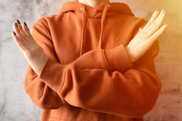 young woman with arms crossed at chest demonstrates break the bias symbol of iwd women's ...