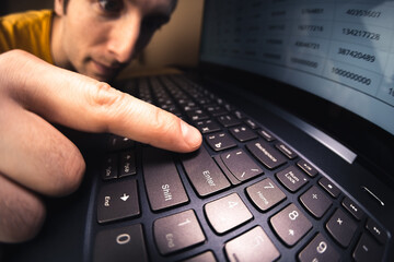 Man pressing enter button on keyboard