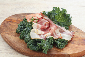 Raw pork bacon over board