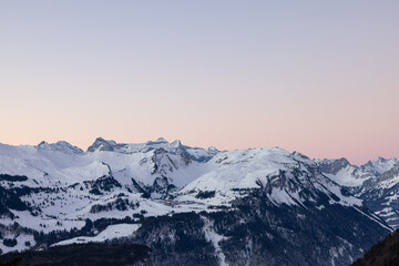 Fototapeta na wymiar Amazing morning view and an epic sunrise with pink and blue tones. Epic long exposure shot in the heart of Switzerland. Wonderful scenery with the mountain called Grosser Mythen in the background.