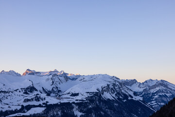 Amazing sunrise with a big mountain in front called Grosser Mythen with sun rays on top. Epic long exposure shot in the heart of Switzerland. Wonderful scenery with the mountain who get shined.