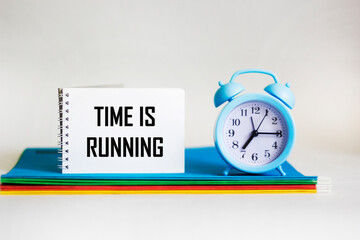 Time is running, text on notepad with clock on white background