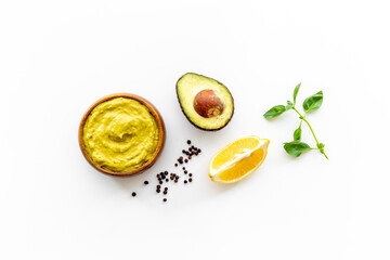 Bowl of guacamole dip with avocado and lime. Homemade guacamole concept