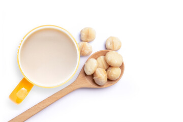 Macadamia milk with macadamia nuts isolated on white background. Top view. Flat lay. Copy space. 