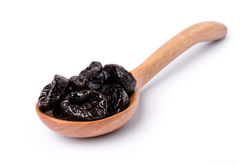 Dried prunes in wooden spoon isolated on white background.