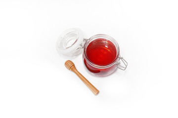 glass jar filled with honey on a white background
