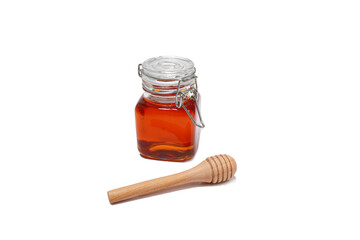 glass jar filled with honey on a white background