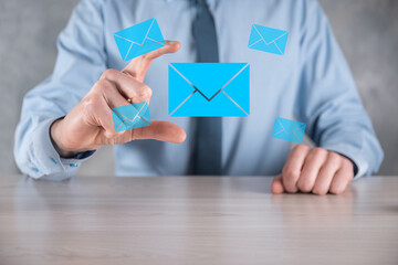 Businessman hand holding e-mail icon, Contact us by newsletter email and protect your personal information from spam mail. Customer service call center contact us concept