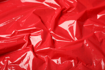 Red plastic stretch wrap as background, closeup