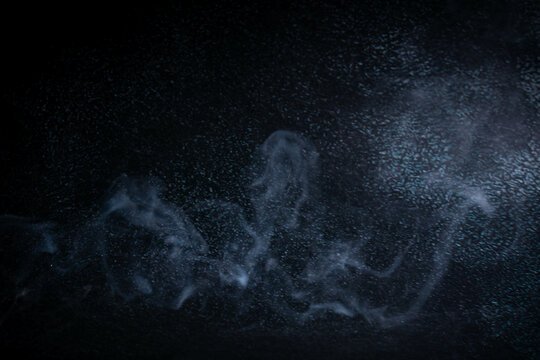 incense and smoke on black background