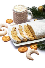 Sliced Traditional Christmas stollen cake with marzipan and dried fruit isolated on ceramic plate