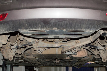 View of the rear multi-link suspension of the car during repair in an auto repair shop