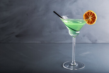 Close up single view of Green margarita with salt and sliced lemon from studio. Includes copy space.