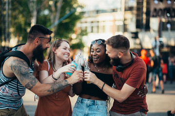 Group of friends drinking cocktails and having fun at music festival