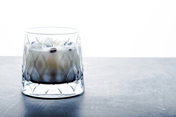 Closeup detail view of White Russian Alcoholic cocktail with copy space.