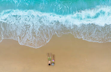 Aerial top view of Relaxation the couple in the holidaywith  sand beaches -Summer  vacation in a holiday concept