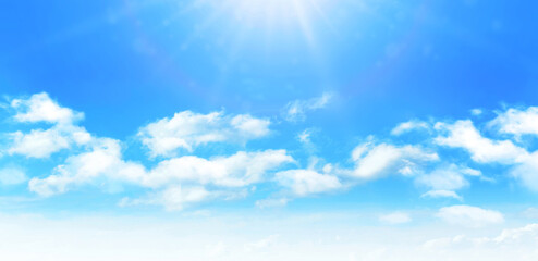 Sunny day background, blue sky with white cumulus clouds and glaring sun