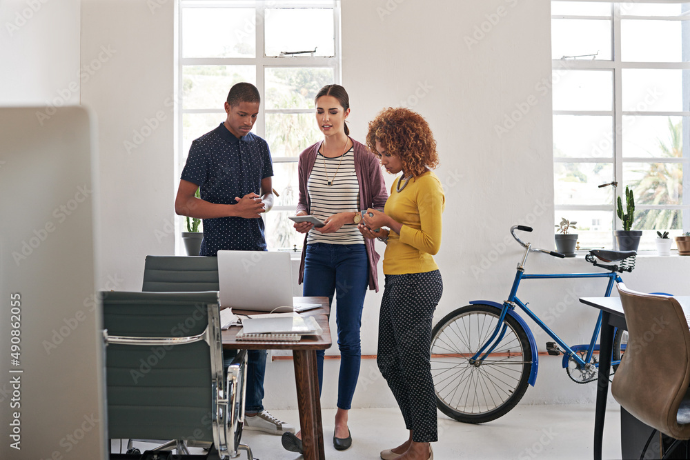 Poster they owe their success to teamwork. shot of a group of colleagues having an informal meeting with a 