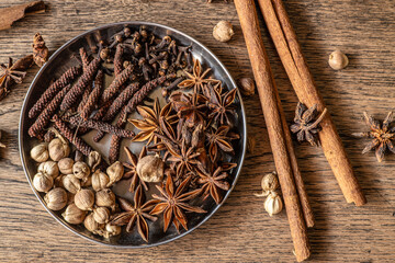 Assorted dry herbal mix indian spice herb natural meditation on wood background