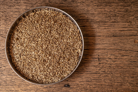 Cumin seed dry from tree basil indian food aroma isolated on wood background