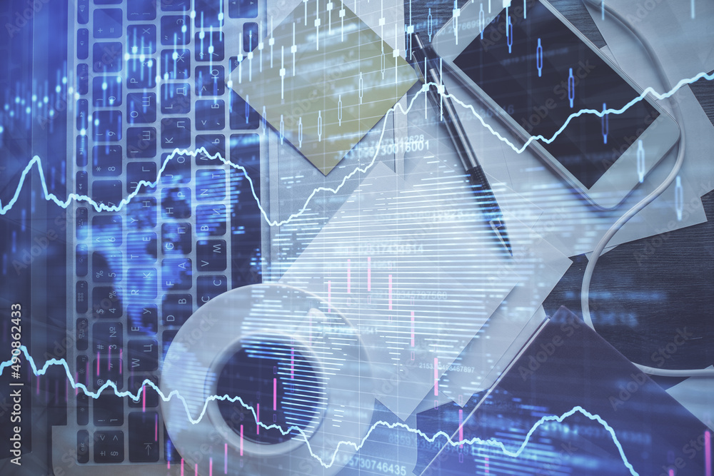 Wall mural Double exposure of financial chart drawing over table background with computer. Concept of research and analysis. Top view.