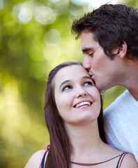 Fototapeta premium Young love. Shot of young couple sharing a tender moment in the park.